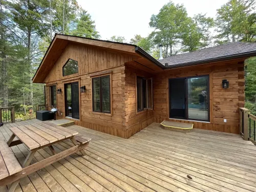 Timber cottage with large deck overlooking the water. Boat access only, no road.
