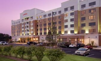 an exterior view of a large hotel , possibly a marriott hotel , located in a city at DoubleTree by Hilton Dulles Airport - Sterling
