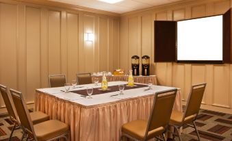 a conference room set up for a meeting with a long table and chairs arranged for a group of people at Four Points by Sheraton Saginaw