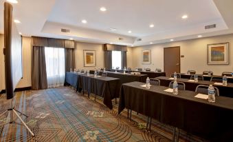 a conference room with tables and chairs arranged in rows , ready for a meeting or event at Hampton Inn-DeKalb (Near the University)