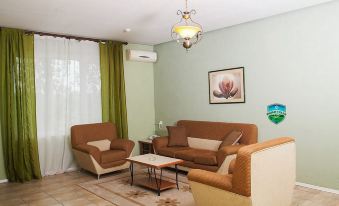 a cozy living room with two couches , a coffee table , and a chandelier hanging from the ceiling at Holiday Village