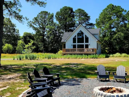 Secluded waterfront getaway with hot tub,fire pit, and private dock.