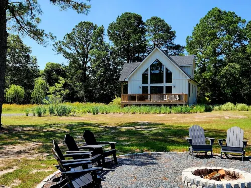 Secluded waterfront getaway with hot tub,fire pit, and private dock.