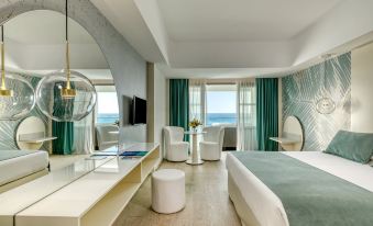 a modern hotel room with a large window overlooking the ocean , a bed , and various furniture at Ivi Mare - Designed for Adults by Louis Hotels