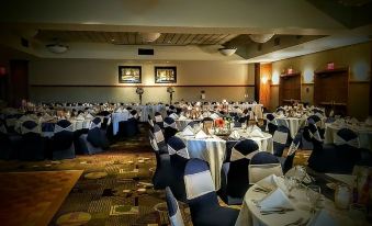 a large banquet hall with many tables and chairs set up for a formal event at Casino Queen Hotel