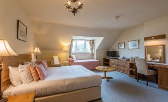 a hotel room with two beds , one on each side of the room , and a tv in the corner at Colwall Park - Hotel, Bar & Restaurant