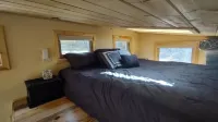 Tiny house on the prairie with mountain views.