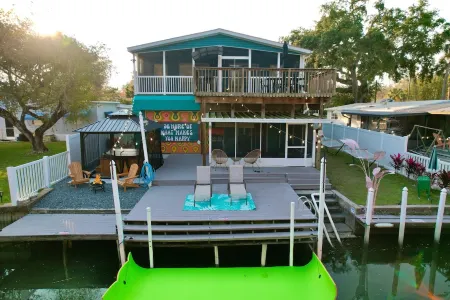 River Home with Huge Arcade, Hot Tub Kayaks, Mini Golf and Floating Pad, 80in TV