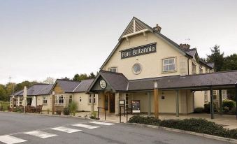 "a large building with a sign that reads "" four seasons town center "" prominently displayed on the front of the building" at Premier Inn Bangor (Gwynedd, North Wales)