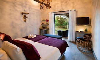 a bedroom with two beds , one on the left side of the room and the other on the right side at Mokuti Etosha