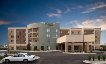 "a modern hotel building with the name "" courtyard by marriott "" prominently displayed on its side" at Courtyard Bay City