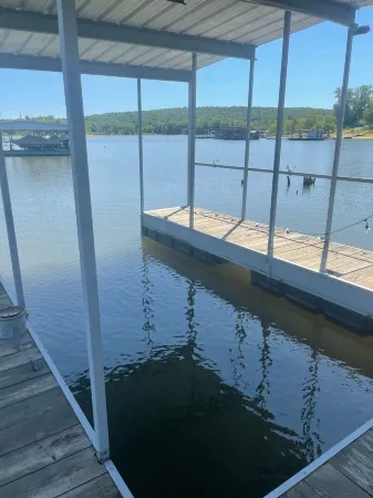 Lake front retreat, covered boat dock, large deck , fenced play area, RV parking