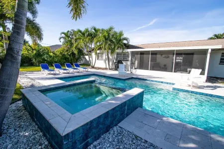 Three-bedroom home with backyard heated pool oasis. 5 minutes to the beach
