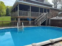 Six bedroom home with a hot tub, pool and an outdoor bar on a two acre lot.
