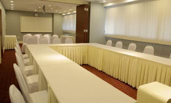 A spacious conference room is arranged with long tables and chairs for hosting events or functions at The Grand Campbell Hotel Kuala Lumpur