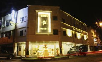 "a hotel building with a large sign that says "" hotel azuni 4 "" is lit up at night" at Era Plus Hotel