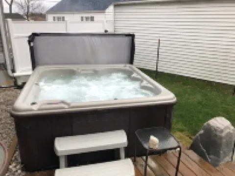 View of Lake Fenton with hot tub and fire place