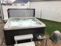 View of Lake Fenton with hot tub and fire place