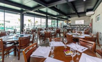 a large dining room with tables and chairs arranged for a group of people to enjoy a meal at Bristol Aline