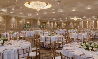 a large banquet hall with multiple tables and chairs set up for a formal event at Druids Glen Resort