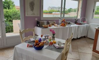 a dining room with a table set for breakfast , complete with plates , cups , and utensils at Stella Marina