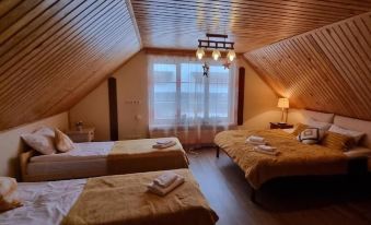 a cozy bedroom with two beds , each covered in white linens and towels , is shown at Porto Resort