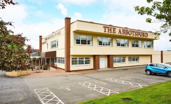"a modern building with the sign "" the abbotsford "" on it , surrounded by trees and other buildings" at Abbotsford Hotel