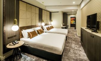 a hotel room with three beds , two of which are twin beds and one is a double bed at DoubleTree by Hilton Wellington