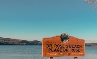 "a wooden sign on the beach says "" dr . rose 's beach place "" and leads to a beautiful shoreline" at Hwy 17 Hotel