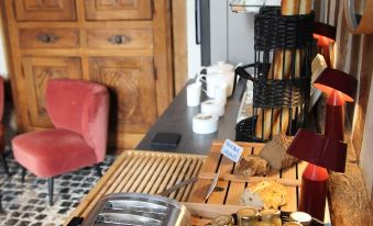 a dining table with a variety of utensils , including forks , knives , spoons , and cups , as well as a variety of at Les Manoirs des Portes de Deauville - Small Luxury Hotel of the World