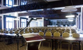 a large conference room with rows of chairs and tables set up for an event at Hotel Diament Zabrze - Gliwice