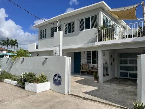 Malecon Beach House with beautiful backyard. Steps from the Caribbean ocean.
