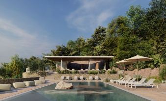 a large outdoor swimming pool surrounded by lounge chairs and umbrellas , providing a relaxing atmosphere at Radisson Resort Skiathos