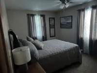Cozy Cabin setting behind a 1 1/2 acre pond that is lined with Cypress Trees.