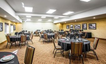 a well - decorated banquet hall with multiple tables and chairs arranged for a formal event or gathering at Comfort Inn & Suites Chillicothe