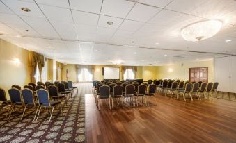 a large conference room with rows of chairs arranged in a semicircle , ready for a meeting or event at Chester Hotel and Conference Center