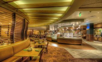 a modern , well - lit restaurant interior with wooden tables and booths , featuring a bar area and comfortable seating at Isle Casino Hotel Waterloo