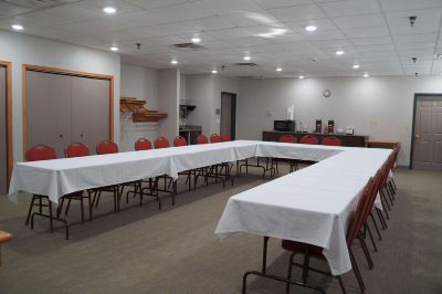 a large conference room with multiple tables and chairs , set up for a meeting or event at Country Inn & Suites by Radisson, Watertown, SD