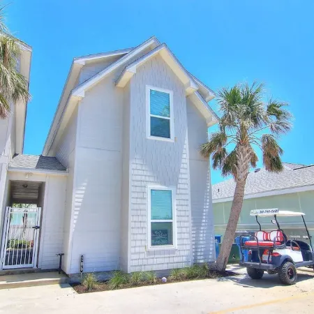 In-town coastal getaway, with a heated pool & level 2 Tesla EV charger on site.