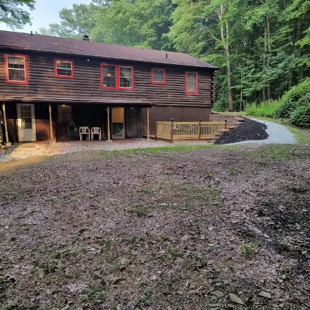 Beautiful cabin situated on wooded land with nice yard clearing and small stream