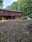 Beautiful cabin situated on wooded land with nice yard clearing and small stream