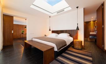 a modern bedroom with a large skylight above the bed , providing natural light and a comfortable space for relaxation at L'And Vineyards