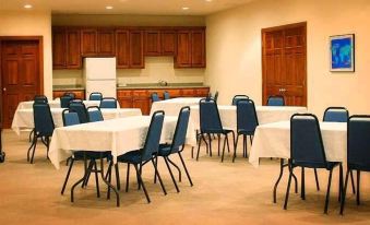 a large dining room with multiple tables and chairs arranged for a group of people at Scandinavian Lodge