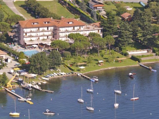 aerial view of a large hotel surrounded by water , with numerous boats docked at the marina at Hotel Marina