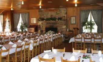 a large dining room filled with tables and chairs , ready for a meal or a party at Graves Mountain Farm & Lodges