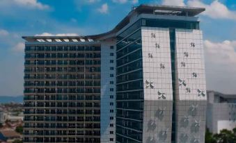 a tall building with a unique design , including vertical glass panels and smaller black windows at Best Western Premier la Grande Hotel