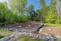 Charming 2-bedroom apartment nestled in a quiet neighborhood with nearby stream.