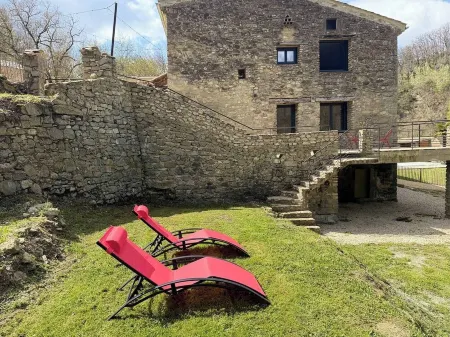 Old mill nestled in greenery in Drôme Provençale, hidden from view