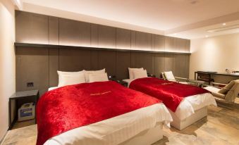 a hotel room with two beds , one on the left and one on the right side of the room at The Empress Hotel