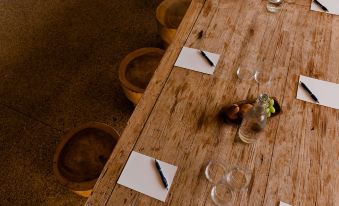 a long wooden dining table set for a meal , with several plates and cups on the table at The Sebel Yarrawonga Silverwoods